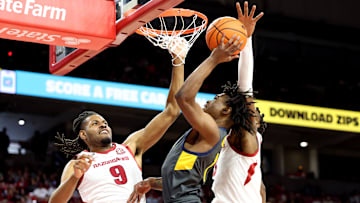Dec 21, 2024; Fayetteville, Arkansas, USA; North Carolina A&T Aggies guard Ryan Forrest (1) attempts a shot in the first half defended by Arkansas Razorbacks forward Jonas Aidoo (9) at Bud Walton Arena. Mandatory Credit: Nelson Chenault-Imagn Images