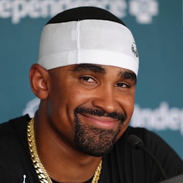 Jul 23, 2025; Philadelphia, PA, USA; Philadelphia Eagles quarterback Jalen Hurts (1) reacts as he addresses media during training camp at NovaCare Complex. Mandatory Credit: Kyle Ross-Imagn Images