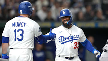 Mar 15, 2025; Bunkyo, Tokyo, Japan; Los Angeles Dodgers right fielder Teoscar Hernandez (37) celebrates with third baseman Max Muncy (13) after hitting a home run against the Yomiuri Giants during the third inning at Tokyo Dome. Mandatory Credit: Darren Yamashita-Imagn Images
