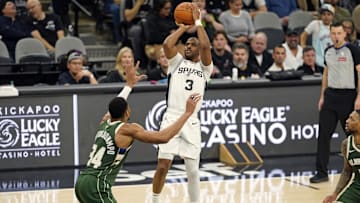 Jan 31, 2025; San Antonio, Texas, USA; San Antonio Spurs guard Chris Paul (3) shoots over Milwaukee Bucks forward Giannis Antetokounmpo (34) during the first half at Frost Bank Center. Mandatory Credit: Scott Wachter-Imagn Images