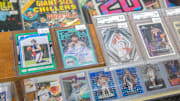 Rare sports cards, some graded for quality, sit in a display shelf at the new shop Stooges Comics and Collectibles in the Oak Cliff Park shopping center in Peoria.