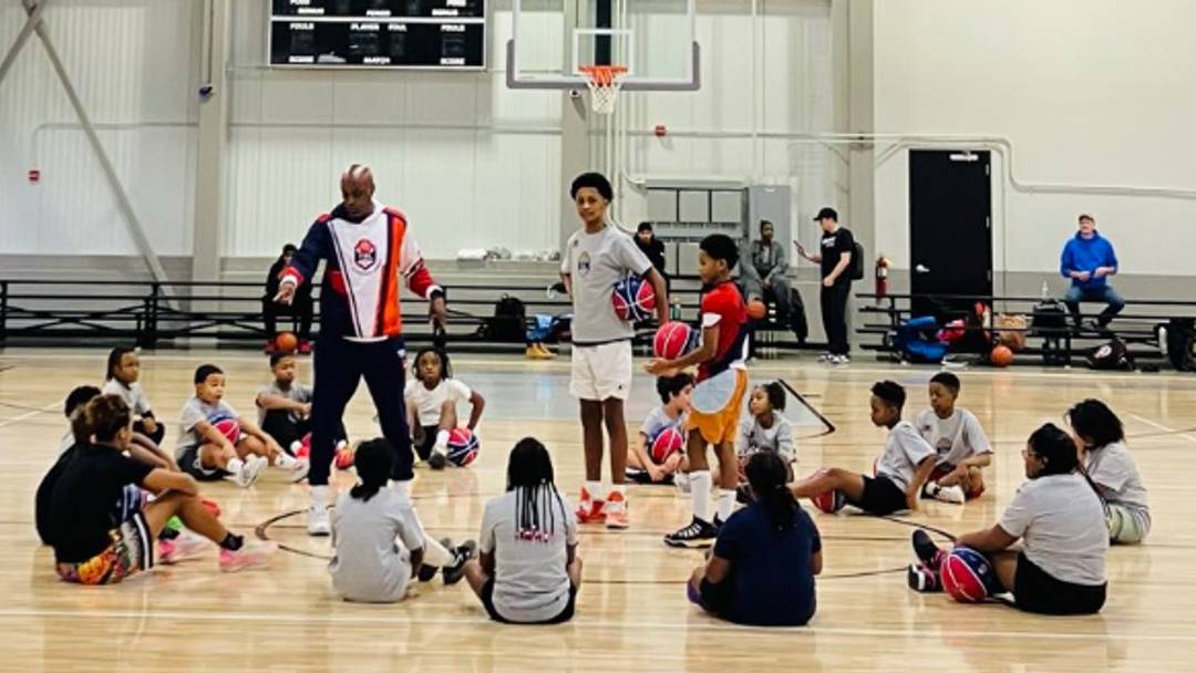 At 14-years old, Blake Gabou (center) leads free youth basketball camp in Indianapolis, Indiana as part of his duties as CEO of the Junior TBL initiative. 