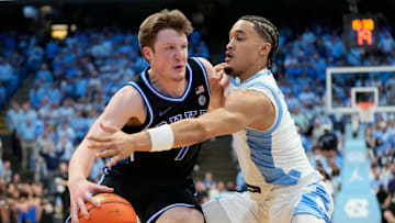 Mar 8, 2025; Chapel Hill, North Carolina, USA;  Duke basketball guard Kon Knueppel (7) with the ball as UNC guard Seth Trimble (7) defends in the first half at Dean E. Smith Center.