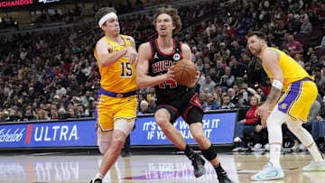 Mar 27, 2025; Chicago, Illinois, USA; Los Angeles Lakers guard Austin Reaves (15) defends Chicago Bulls forward Matas Buzelis (14) 