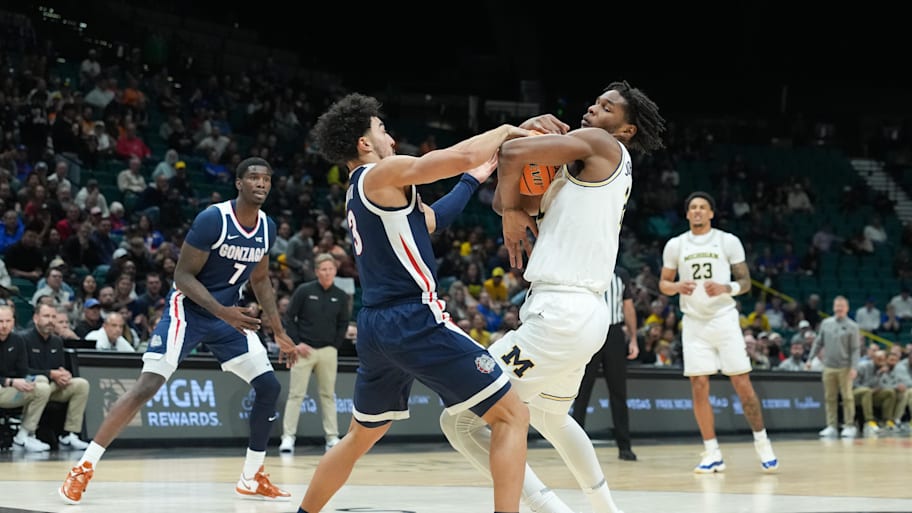 Gonzaga guard Braeden Smith and Michigan forward Morez Johnson Jr. battle for the ball.