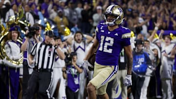 Sep 6, 2025; Seattle, Washington, USA; Washington Huskies wide receiver Denzel Boston (12) returns a punt for a touchdown against the UC Davis Aggies during the second quarter at Husky Stadium. Mandatory Credit: Joe Nicholson-Imagn Images