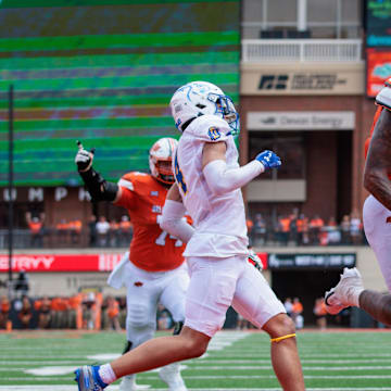 Aug 31, 2024; Stillwater, Oklahoma, USA; Oklahoma State Cowboys running back Ollie Gordon II (0) leaps into the endzone for a touchdown during the second quarter against the South Dakota State Jackrabbits at Boone Pickens Stadium. Mandatory Credit: William Purnell-Imagn Images