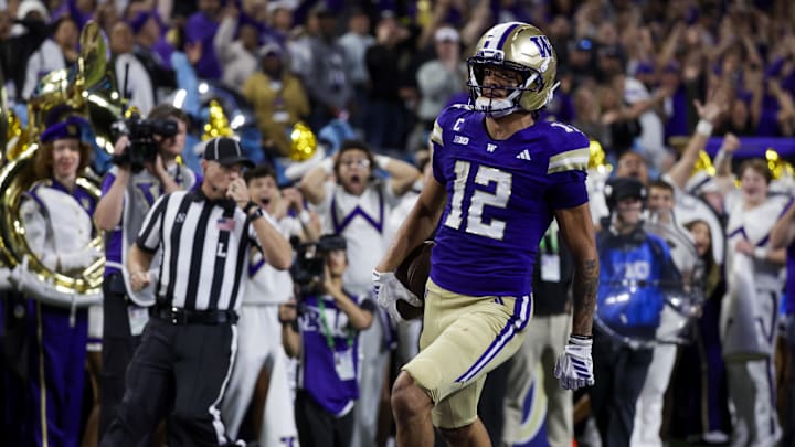 Sep 6, 2025; Seattle, Washington, USA; Washington Huskies wide receiver Denzel Boston (12) returns a punt for a touchdown against the UC Davis Aggies during the second quarter at Husky Stadium. Mandatory Credit: Joe Nicholson-Imagn Images