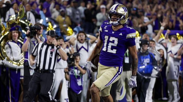 Sep 6, 2025; Seattle, Washington, USA; Washington Huskies wide receiver Denzel Boston (12) returns a punt for a touchdown against the UC Davis Aggies during the second quarter at Husky Stadium. Mandatory Credit: Joe Nicholson-Imagn Images