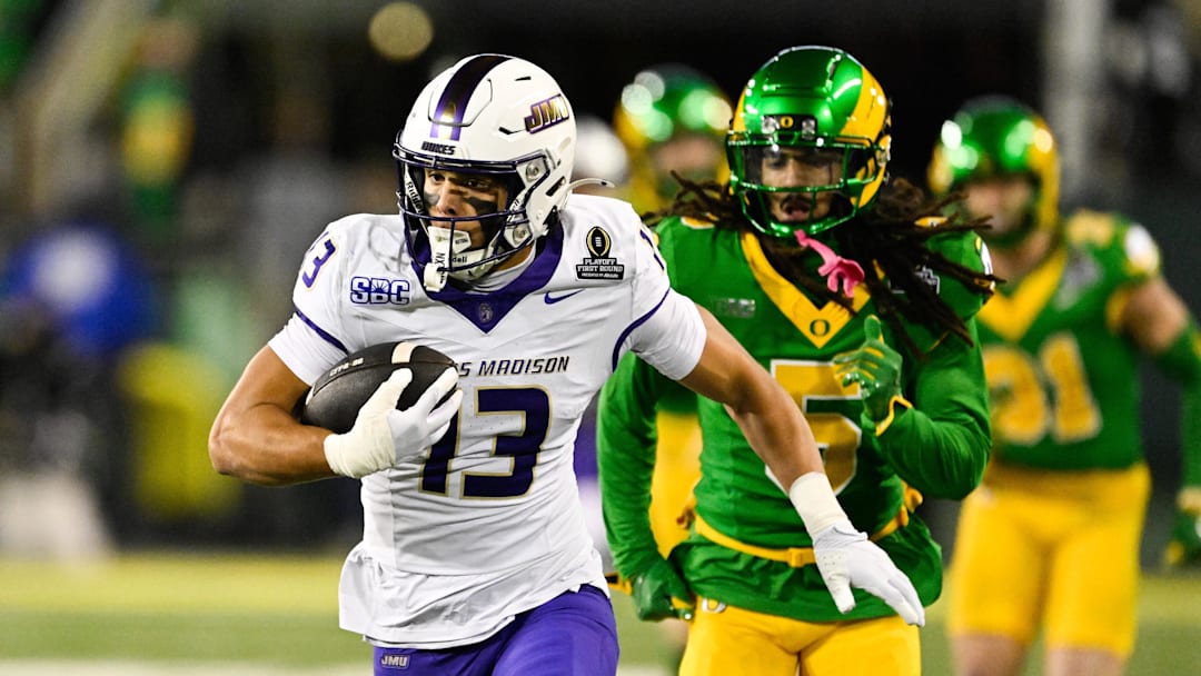 James Madison Dukes wide receiver Landon Ellis (13) runs after making a catch as Oregon Ducks defensive back Theran Johnson (5) defends during the second quarter at Autzen Stadium. 