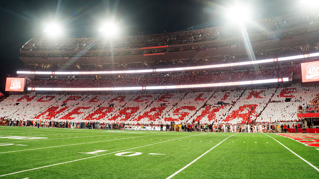 Sep 20, 2024; Lincoln, Nebraska, USA; Fans hold cards to commemorate the 400th consecutive sellout after the first quarter between the Nebraska Cornhuskers and the Illinois Fighting Illini.