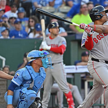 May 10, 2025; Kansas City, Missouri, USA;  Boston Red Sox designated hitter Rafael Devers (11) hits an RBI double in the third inning against the Kansas City Royals at Kauffman Stadium. Mandatory Credit: Peter Aiken-Imagn Images