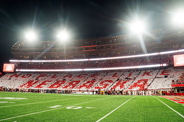 Fans hold cards to commemorate the 400th consecutive sellout after the first quarter between the Nebraska Cornhuskers and the