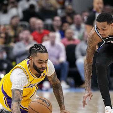 Jan 30, 2024; Atlanta, Georgia, USA; Los Angeles Lakers guard D'Angelo Russell (1) loses and dives for the ball next to Atlanta Hawks guard Dejounte Murray (5) during the second half at State Farm Arena. Mandatory Credit: Dale Zanine-Imagn Images