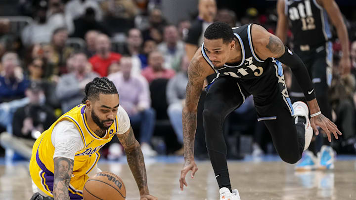 Jan 30, 2024; Atlanta, Georgia, USA; Los Angeles Lakers guard D'Angelo Russell (1) loses and dives for the ball next to Atlanta Hawks guard Dejounte Murray (5) during the second half at State Farm Arena. Mandatory Credit: Dale Zanine-Imagn Images