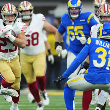 Oct 2, 2025; Inglewood, California, USA; San Francisco 49ers running back Christian McCaffrey (23) rushes the ball against the Los Angeles Rams during the first half at SoFi Stadium. Mandatory Credit: Kirby Lee-Imagn Images
