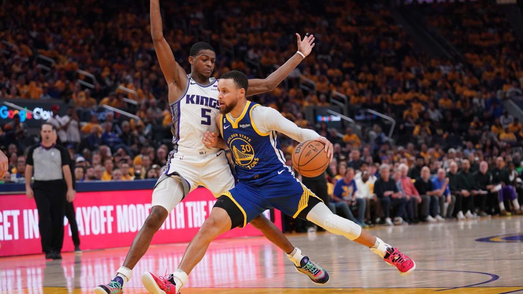 Apr 28, 2023; San Francisco, California, USA; Golden State Warriors guard Stephen Curry (30) dribbles the ball next to Sacramento Kings guard De'Aaron Fox (5) in the second quarter during game six of the 2023 NBA playoffs at the Chase Center. Mandatory Credit: Cary Edmondson-USA TODAY Sports