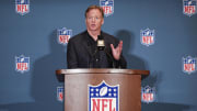Roger Goodell speaks to media at an NFL podium.