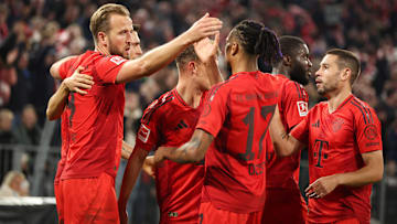 Bayern Munich players celebrating Harry Kane's goal against VfB Stuttgart.