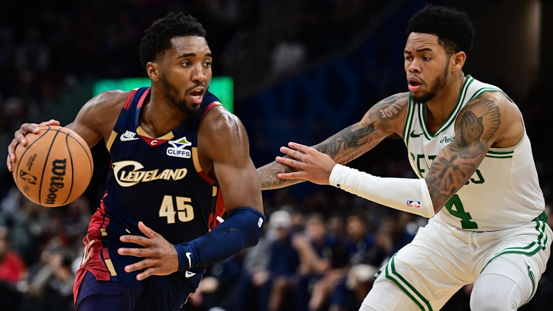 Nov 30, 2025; Cleveland, Ohio, USA; Cleveland Cavaliers guard Donovan Mitchell (45) drives on Boston Celtics guard Anfernee Simons (4) during the second half at Rocket Arena. Mandatory Credit: David Dermer-Imagn Images