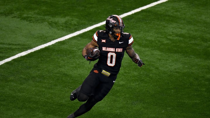 Dec 2, 2023; Arlington, TX, USA;  Oklahoma State Cowboys running back Ollie Gordon II (0) runs with the ball against the Texas Longhorns during the first quarter at AT&T Stadium. Mandatory Credit: Jerome Miron-USA TODAY Sports