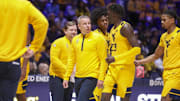 Nov 13, 2025; Morgantown, West Virginia, USA; West Virginia Mountaineers head coach Ross Hodge talks with West Virginia Mountaineers guard Morris Ugusuk (23) during the first half against the Pittsburgh Panthers at WVU Coliseum. Mandatory Credit: Ben Queen-Imagn Images