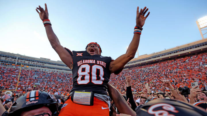 Oklahoma State's Brennan Presley (80) celebrates with teammates following Bedlam