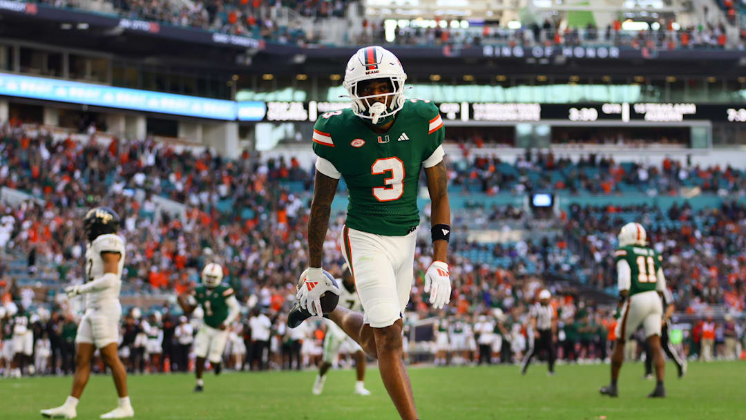 Nov 23, 2024; Miami Gardens, Florida, USA; Miami Hurricanes wide receiver Jacolby George (3) scores a touchdown against the Wake Forest Demon Deacons during the fourth quarter at Hard Rock Stadium. Mandatory Credit: Sam Navarro-Imagn Images