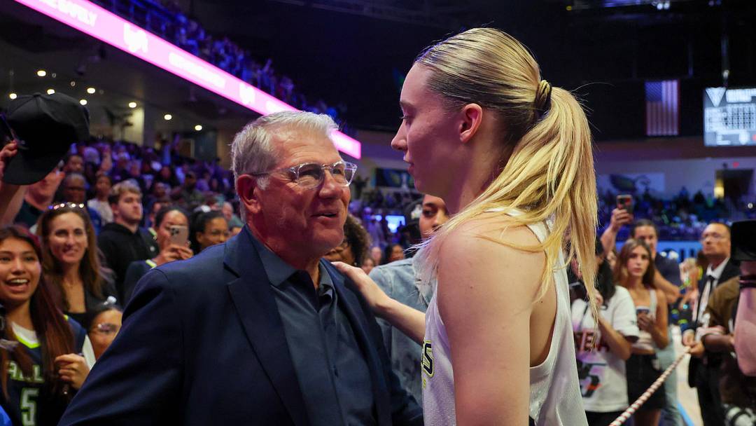 Jun 17, 2025; Arlington, Texas, USA;  University of Connecticut head coach Geno Auriemma speaks with Dallas Wings guard Paige Bueckers (5) after the game against the Golden State Valkyries at College Park Center. Mandatory Credit: Kevin Jairaj-Imagn Images