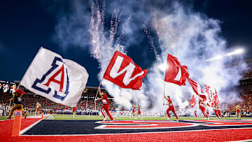 Sep 7, 2024; Tucson, Arizona, USA; Arizona Wildcats cheerleaders runout with flags as they lead the team onto the field before the game against Northern Arizona Lumberjacks at Arizona Stadium. Mandatory Credit: Aryanna Frank-Imagn Images