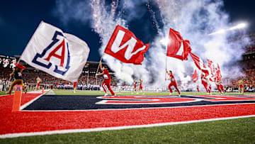 Sep 7, 2024; Tucson, Arizona, USA; Arizona Wildcats cheerleaders runout with flags as they lead the team onto the field before the game against Northern Arizona Lumberjacks at Arizona Stadium. Mandatory Credit: Aryanna Frank-Imagn Images