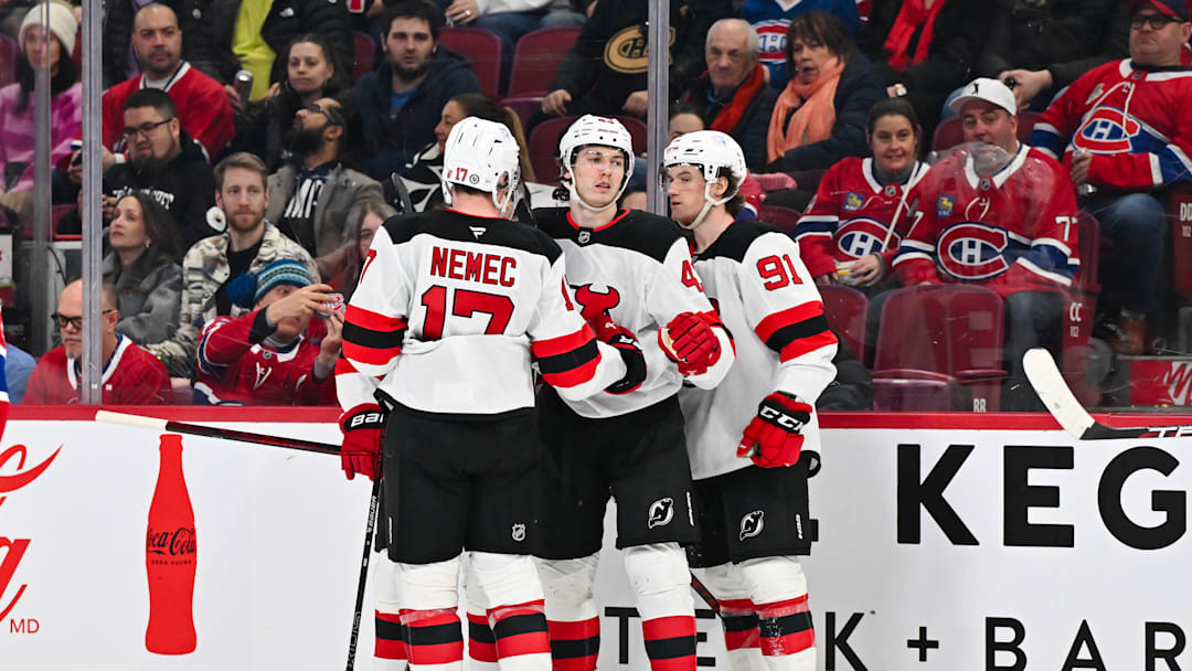 Simon Nemec and Luke Hughes celebrate a goal with New Jersey Devils teammate Dawson Mercer