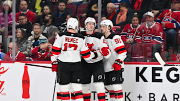 Simon Nemec and Luke Hughes celebrate a goal with New Jersey Devils teammate Dawson Mercer