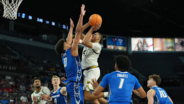 Nov 24, 2025; Las Vegas, Nevada, USA; Baylor Bears guard Cameron Carr (43) shoots over Creighton Bluejays forward Jasen Green (0) during the first half in a 2025 Players Era Festival group play game at Michelob Ultra Arena. Mandatory Credit: Kirby Lee-Imagn Images