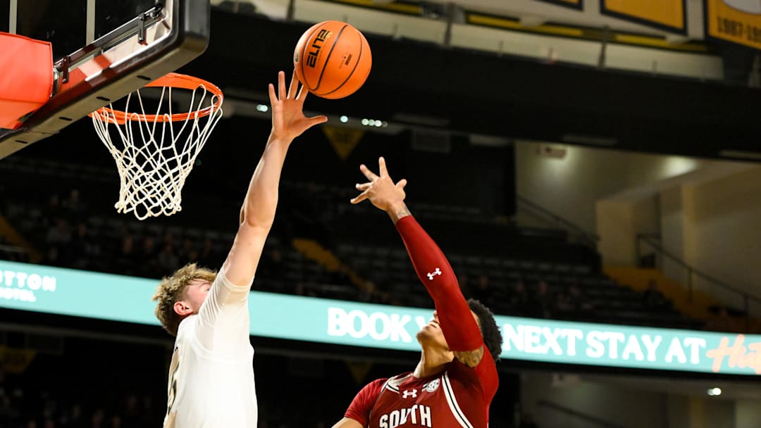 Jan 15, 2025; Nashville, Tennessee, USA;  Vanderbilt Commodores guard Tyler Nickel (5) blocks the shot of South Carolina Gamecocks guard Arden Conyers (21) during the first half at Memorial Gymnasium.