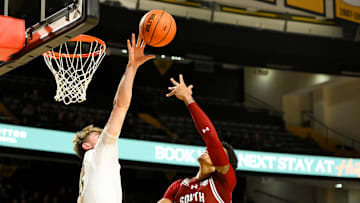 Jan 15, 2025; Nashville, Tennessee, USA;  Vanderbilt Commodores guard Tyler Nickel (5) blocks the shot of South Carolina Gamecocks guard Arden Conyers (21) during the first half at Memorial Gymnasium.