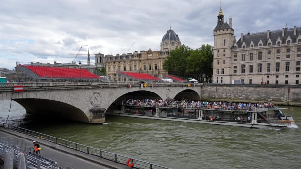 Boat traveling down Seine River in Paris.