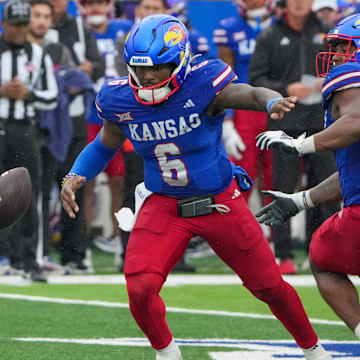 Oct 25, 2025; Lawrence, Kansas, USA; Kansas Jayhawks quarterback Jalon Daniels (6) looses the ball from a bad snap against the Kansas State Wildcats during the second half of the game at David Booth Kansas Memorial Stadium. Mandatory Credit: Denny Medley-Imagn Images