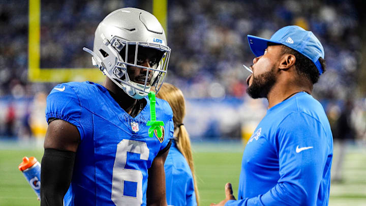 Detroit Lions cornerback Terrion Arnold (6) talks to running backs coach Tashard Rice at warmup ahead of the Green Bay Packers game at Ford Field in Detroit on Thursday, Nov. 27, 2025.