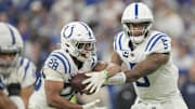 Dec 22, 2024; Indianapolis, Indiana, USA; Indianapolis Colts quarterback Anthony Richardson (5) hands the ball off to Indianapolis Colts running back Jonathan Taylor (28) during a game against the Tennessee Titans  at Lucas Oil Stadium. 