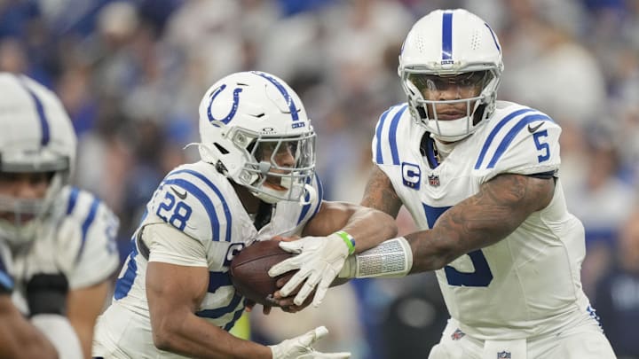 Dec 22, 2024; Indianapolis, Indiana, USA; Indianapolis Colts quarterback Anthony Richardson (5) hands the ball off to Indianapolis Colts running back Jonathan Taylor (28) during a game against the Tennessee Titans at Lucas Oil Stadium. Dec 22, 2024; Indianapolis, Indiana, USA; Indianapolis Colts quarterback Anthony Richardson (5) hands the ball off to Indianapolis Colts running back Jonathan Taylor (28) during a game against the Tennessee Titans at Lucas Oil Stadium.