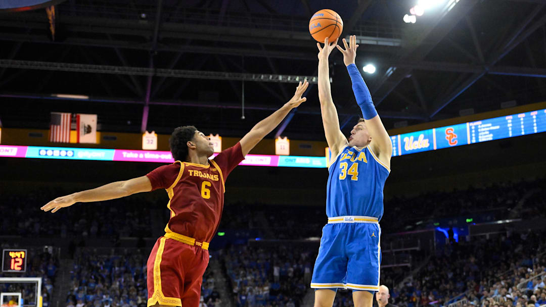 Feb 24, 2026; Los Angeles, California, USA; UCLA Bruins forward Tyler Bilodeau (34) shoots over Southern California Trojans forward Jacob Cofie (6) during the second half at Pauley Pavilion presented by Wescom Financial. Mandatory Credit: Robert Hanashiro-Imagn Images