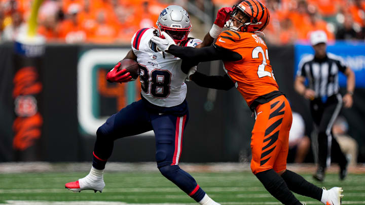 New England Patriots running back Rhamondre Stevenson (38) breaks a tackle from Cincinnati Bengals safety Geno Stone (22) on a carry in the first quarter of the NFL Week 1 game between the Cincinnati Bengals and the New England Patriots at Paycor Stadium in downtown Cincinnati on Sunday, Sept. 8, 2024.