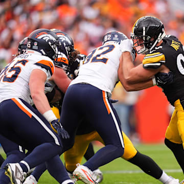 Sep 15, 2024; Denver, Colorado, USA; Denver Broncos tight end Adam Trautman (82) blocks Pittsburgh Steelers linebacker T.J. Watt (90) in the second half at Empower Field at Mile High. Mandatory Credit: Ron Chenoy-Imagn Images