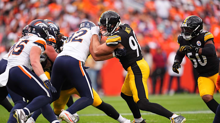 Sep 15, 2024; Denver, Colorado, USA; Denver Broncos tight end Adam Trautman (82) blocks Pittsburgh Steelers linebacker T.J. Watt (90) in the second half at Empower Field at Mile High. Mandatory Credit: Ron Chenoy-Imagn Images