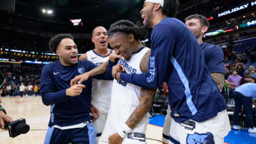 Dec 19, 2023; New Orleans, Louisiana, USA; Memphis Grizzlies guard Ja Morant, center, is mobbed by