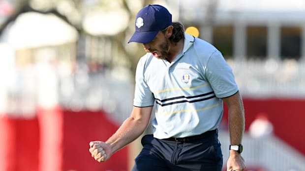 Team Europe golfer Tommy Fleetwood celebrates after his putt on the 16th green on the first day of competition for the Ryder 