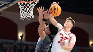 Nov 28, 2025; San Diego, CA, USA; Wisconsin Badgers forward Nolan Winter (31) blocks Texas Christian University Horned Frogs forward David Punch (15) during the second half at Jenny Craig Pavilion. Mandatory Credit: Abe Arredondo-Imagn Images