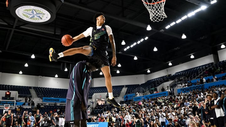 Apr 1, 2024; Houston, TX, USA; McDonalds High School All American guard Jalil Bethea (1) jumps over seven foot two center J.Bol (7) and dunks the ball during the dunk competition in the 2024 McDonalds High School All American Powerade Jam Fest at Delmar Fieldhouse. Mandatory Credit: Maria Lysaker-USA TODAY Sports