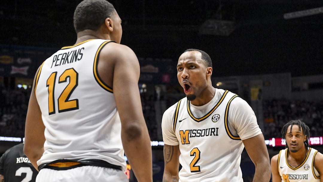 Missouri Tigers guards Tony Perkins (12) and Tamar Bates (2) celebrate after a bucket on offense, in a game versus the Mississippi State Bulldogs this season.